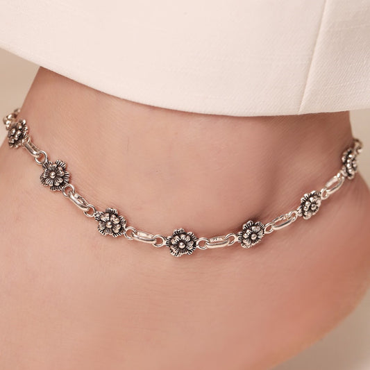 Woman wearing a floral 925 Sterling Silver anklet. Beautiful silver blossom jewellery for women – Zavya