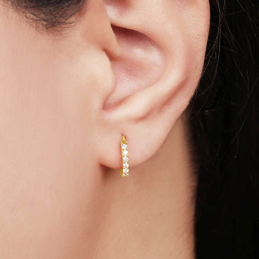 Woman wearing stone-studded 925 Sterling Silver gold hoop earrings. Everyday jewellery for women – Zavya