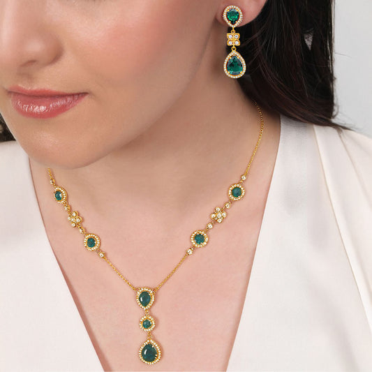 Woman wearing a gold-plated 925 Sterling Silver emerald necklace & earrings. Women's jewellery set – Zavya